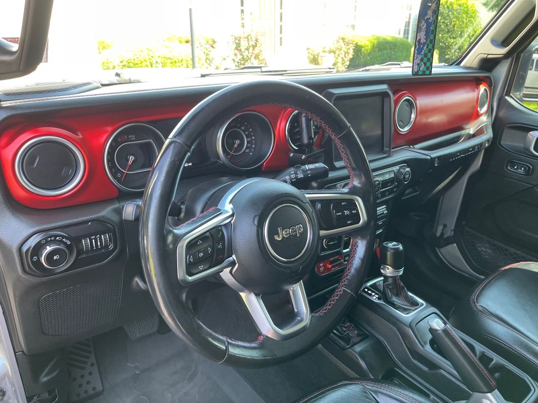 Interior detail on a Jeep, dash, console and red accent seating wiped down and refreshed.