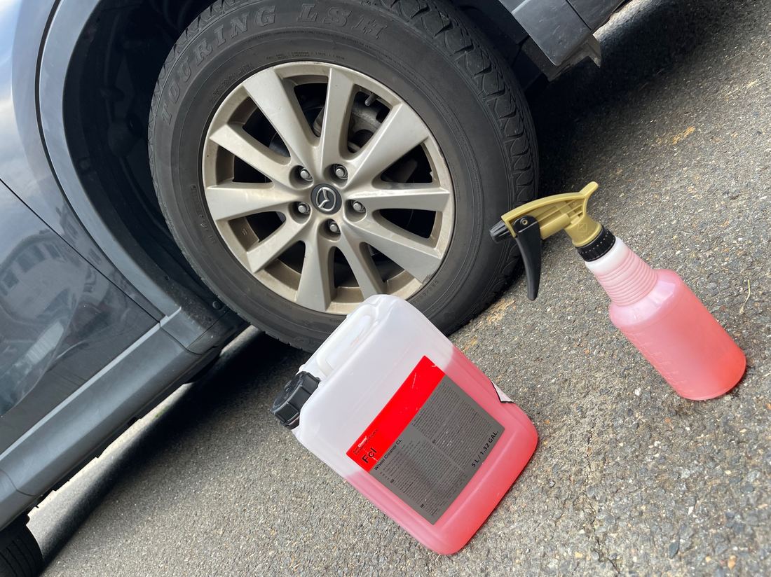 Wheel and tire cleaning products staged and ready before a mobile detail.