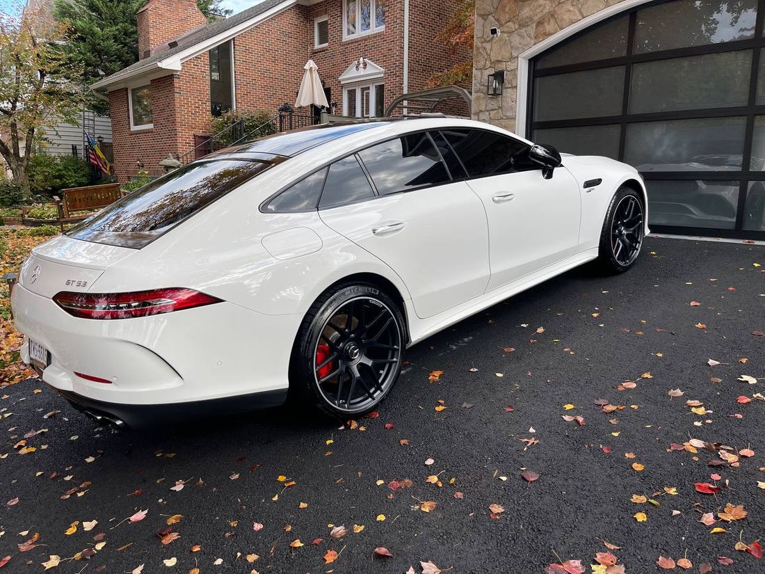 Sedan detailed in a residential garage, protected from the weather.