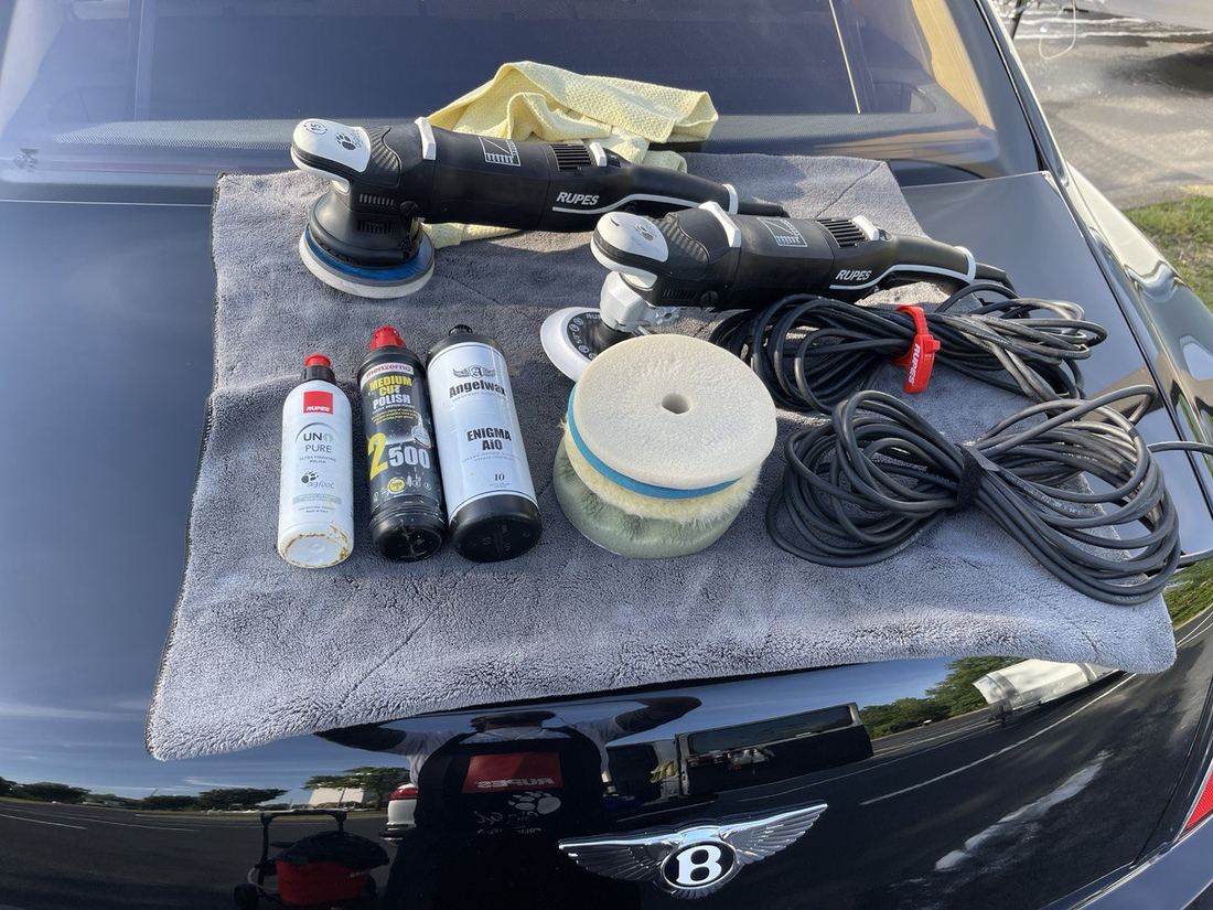 Professional polishing and paint correction tools staged for a job.
