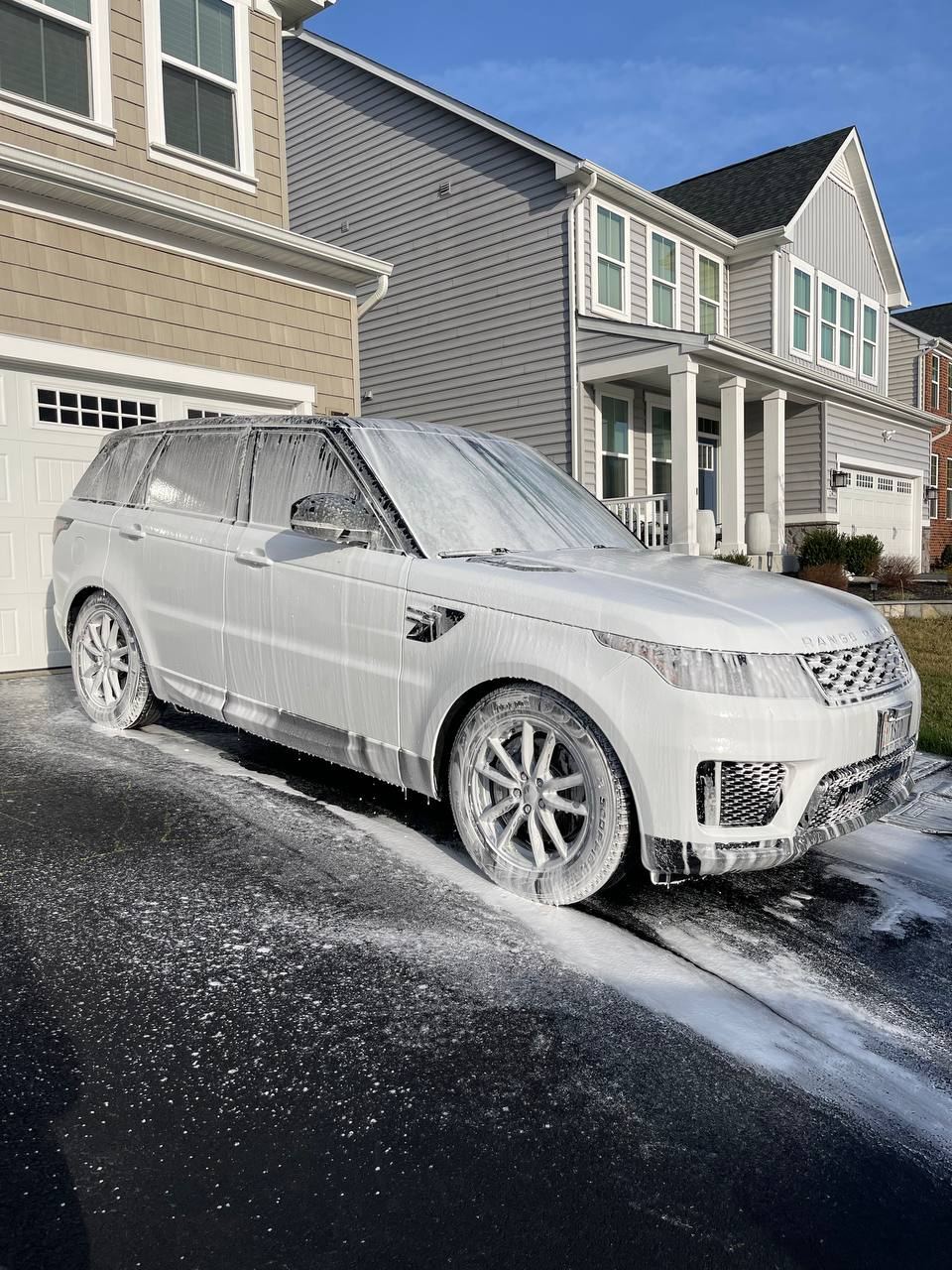 White SUV getting a hand wash in a Northern Virginia driveway.