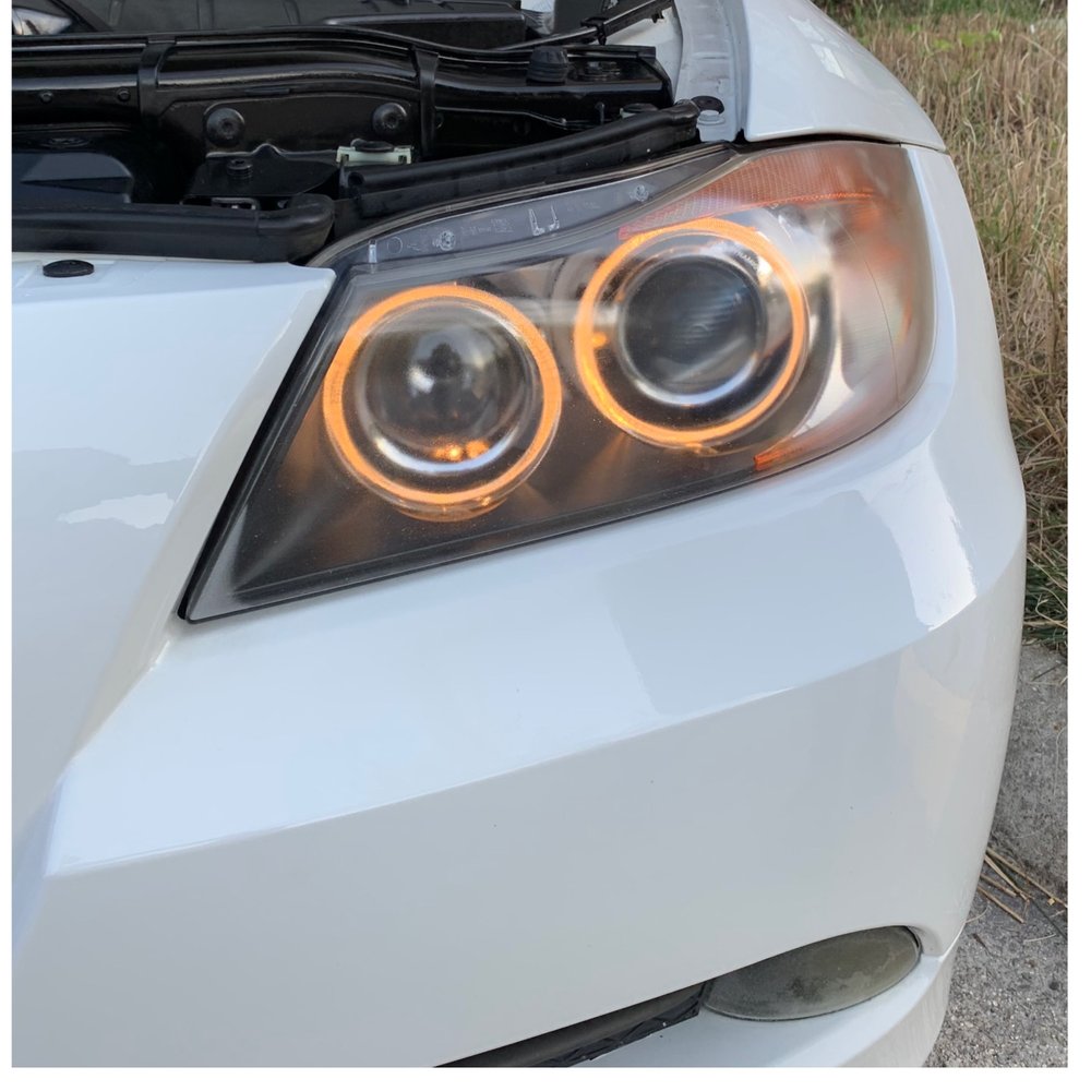 Headlight before restoration, showing yellowed and oxidized lens